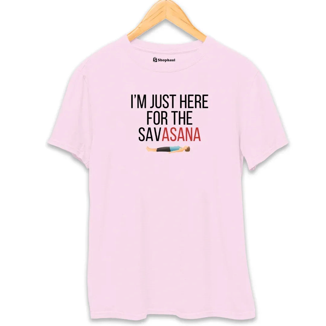 Light pink yoga t-shirt with 'I'm Just Here For The Savasana' text and illustrated graphic.